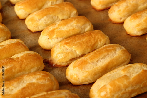 Freshly baked choux pastry. Making Eclair.
