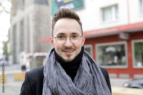 Portrait of smiling young man in the city in winter photo