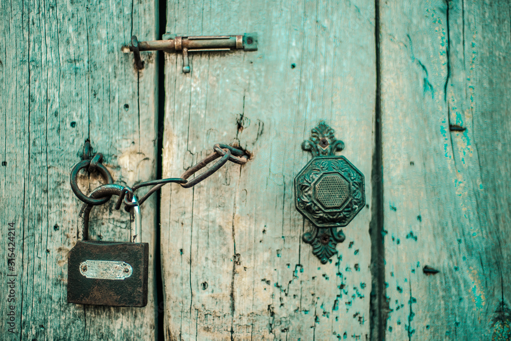 Old wooden door with handle, heck and lock. Boho style. Old wooden door with handle, heck and lock. Boho style.