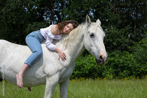 Portrait of young woman sitting bareback on a horse