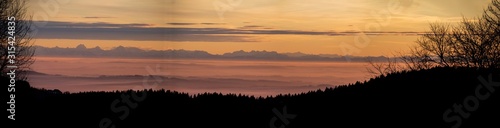 Fototapeta Naklejka Na Ścianę i Meble -  High resolution stitched panorama of a beautiful sunset with the distant alps in the background near Daxstein, Bavarian forest, Bavaria, Germany