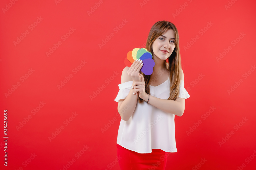 lesbian woman with lgbt colors heart shapes isolated over red