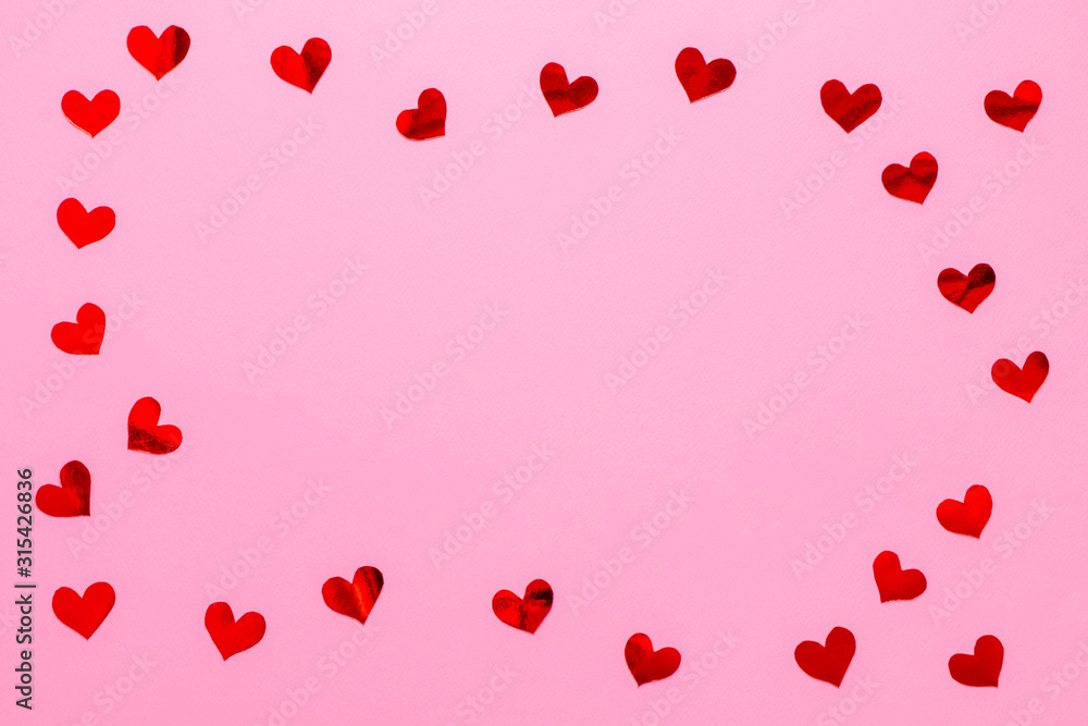 Red paper hearts confetti frame on pink background