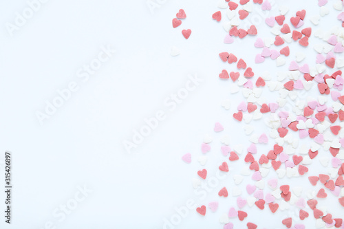 Heart shaped sprinkles on white background