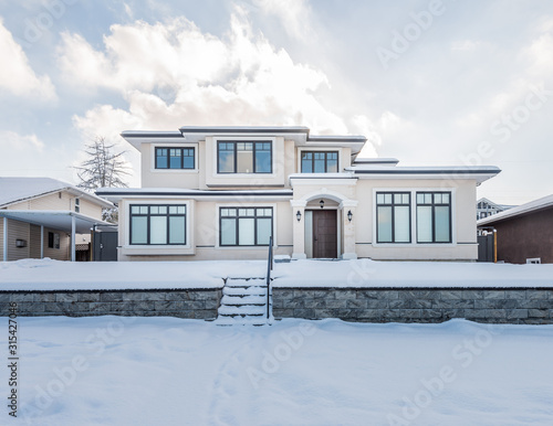 A perfect neighbourhood. Houses in suburb at Winter in the north America. Luxury houses covered nice snow.