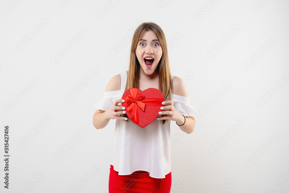 Fototapeta premium pretty woman with red heart shaped valentine gift box isolated on white background