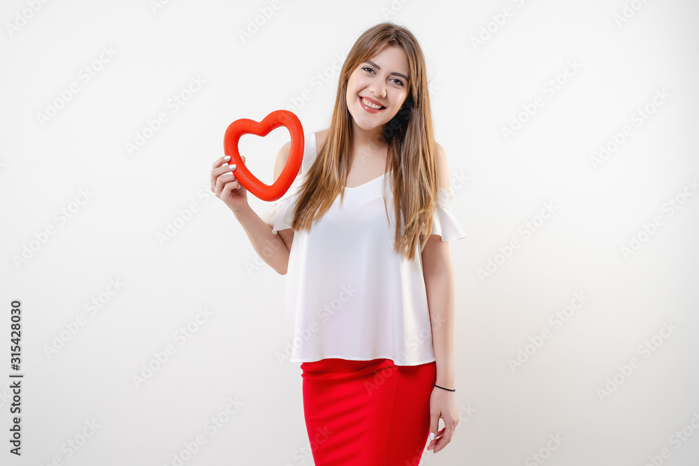 beautiful woman with red heart shape smiling isolated on white background beautiful woman with red heart shape smiling isolated on white background