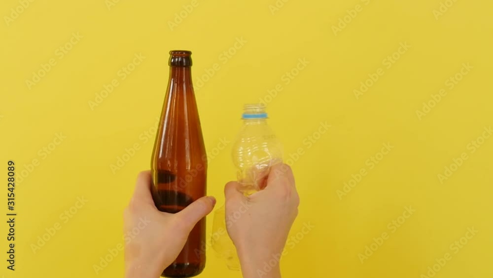 Sorting garbage. On a yellow background, plastic, paper, polyethylene in the hands of people. Ecology of saving the planet. Sorting garbage. On a yellow background, plastic, paper, polyethylene in the hands of people. Ecology of saving the planet.