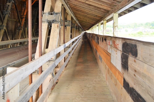 The walkway inside the covered bridge at Hardford for people to walk across.