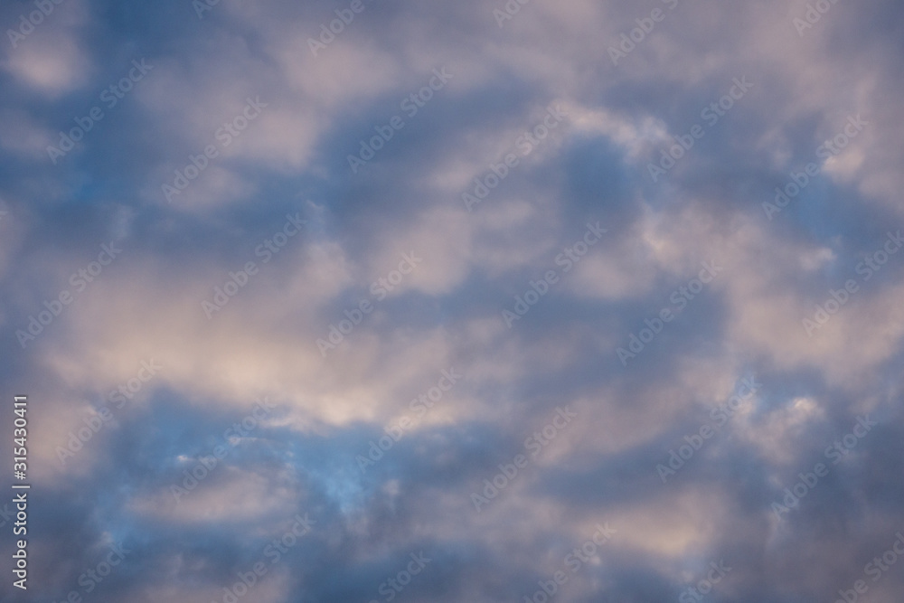 Blue winter sky and cumulus heavy clouds. Windy weather. High quality photo.