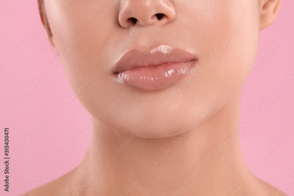 Young woman with beautiful full lips on pink background, closeup Young woman with beautiful full lips on pink background, closeup