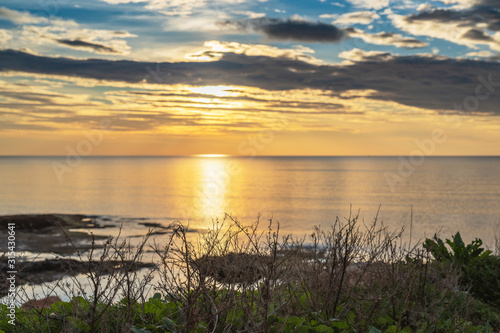 Early sunrise and epic cloudy sky at rocky seashore coast of Torrevieja, Alicante, Spain. Mediterranean sea 2019