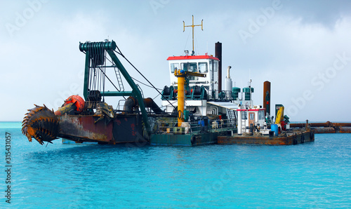Dredger Heavy Excavator on Water in the Sea (Deep Sea Dredge) photo