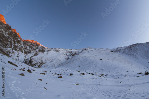 Snowy foothills at sunset time. Beautiful natural background with Caucasus mountains