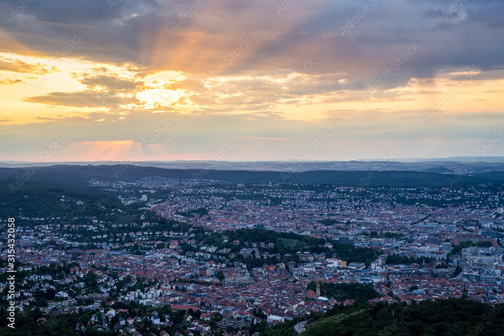 Germany, Metropolitan area of city stuttgart from aerial perspective above the houses, roofs and buildings at sunset in summer