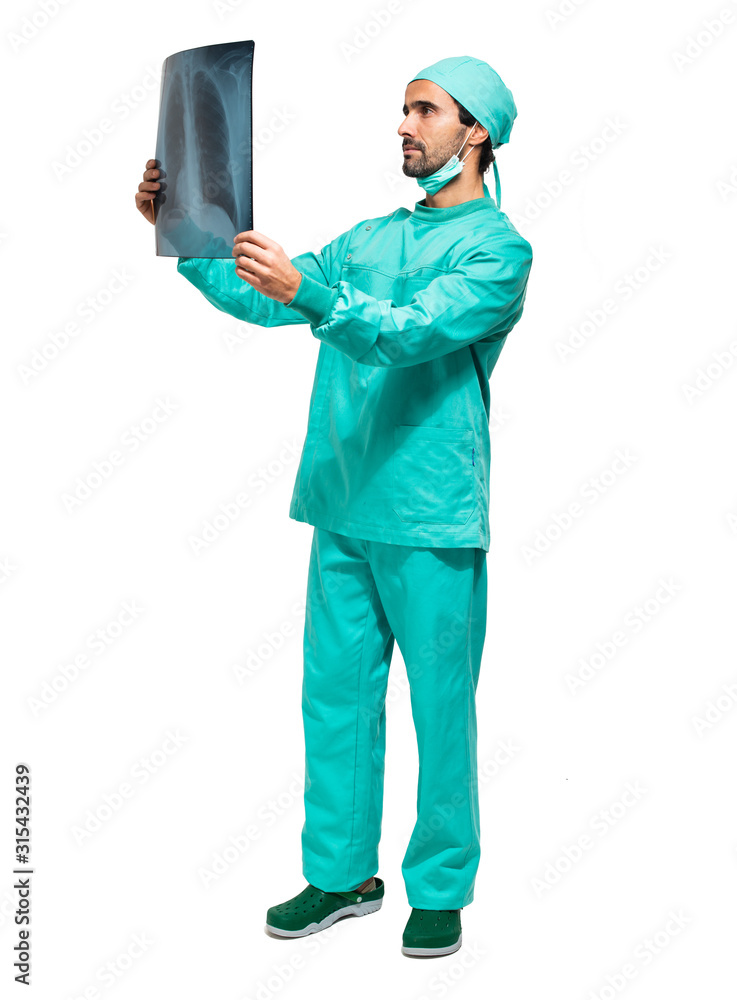 Surgeon analyzing a lung radiography isolated on white full length portrait Surgeon analyzing a lung radiography isolated on white full length portrait