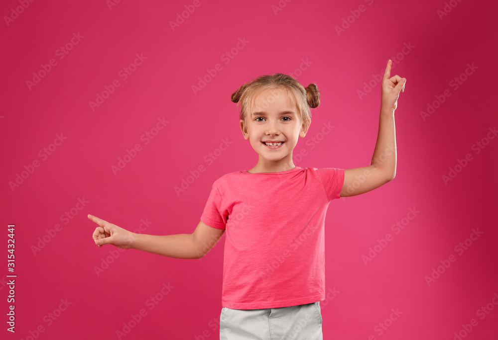 Cute little girl posing on pink background Cute little girl posing on pink background