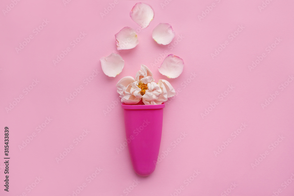 Rosebud and delicate petals in ice cream sculpt on a pink background. Space for text. flower composition