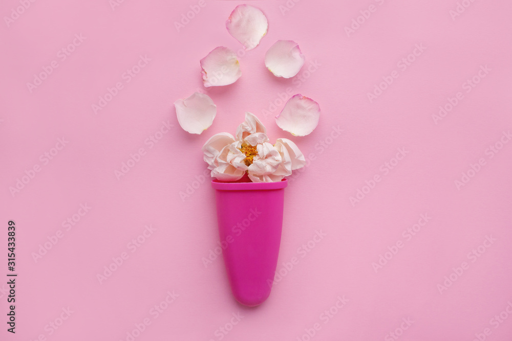 Rosebud and delicate petals in ice cream sculpt on a pink background. Space for text. flower composition Rosebud and delicate petals in ice cream sculpt on a pink background. Space for text. flower composition