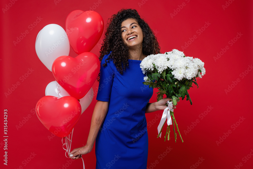 beautiful black woman with heart shaped balloons and white flower bouquet on red background beautiful black woman with heart shaped balloons and white flower bouquet on red background