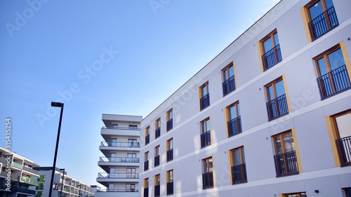 Contemporary residential building exterior in the daylight. Modern apartment buildings on a sunny day with a blue sky. Facade of a modern apartment building