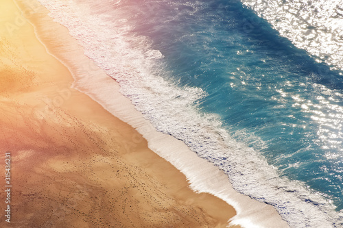 Top view of beautiful empty sand beach with waves