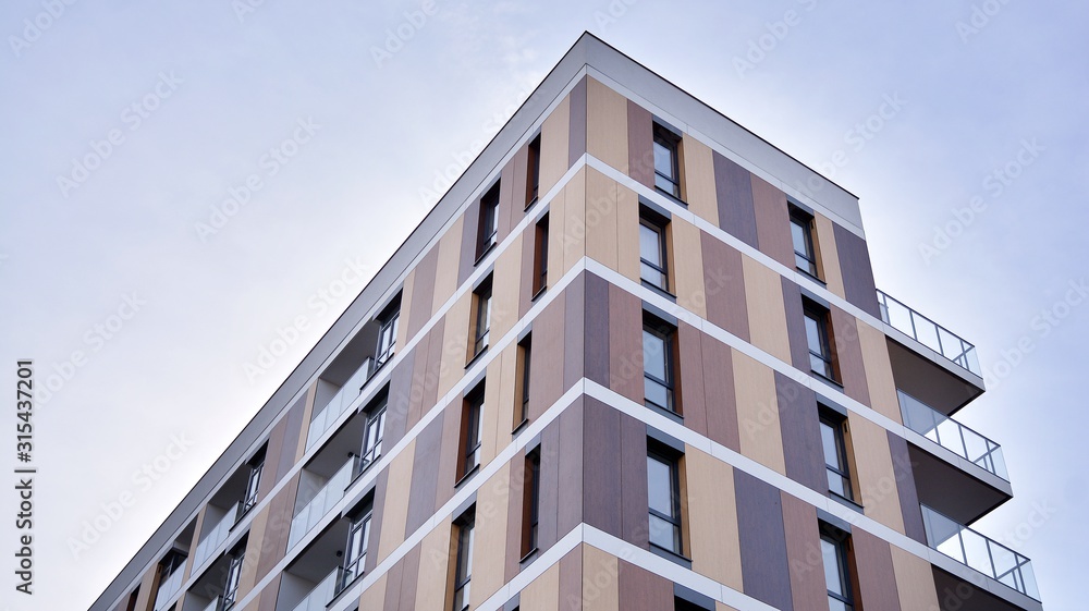 Contemporary residential building exterior in the daylight. Modern apartment buildings on a sunny day with a blue sky. Facade of a modern apartment building Contemporary residential building exterior in the daylight. Modern apartment buildings on a sunny day with a blue sky. Facade of a modern apartment building