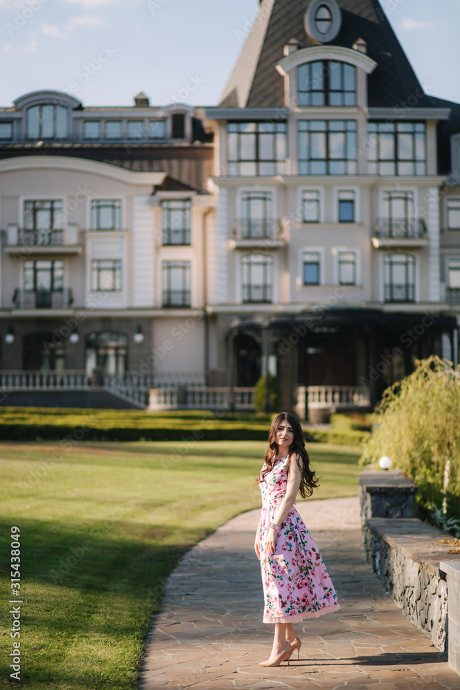 Elegant lady walking by the hotel. Spring day Elegant lady walking by the hotel. Spring day
