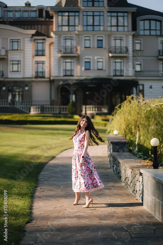 Elegant lady walking by the hotel. Spring day © Aleksandr