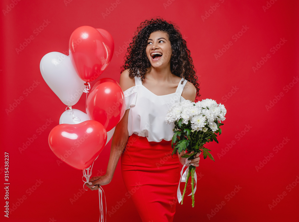 beautiful black woman with heart shaped balloons and bouquet of white flowers isolated on red beautiful black woman with heart shaped balloons and bouquet of white flowers isolated on red