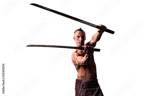 A man with two katanas in his hands, in the blood of the enemy. Strikes. Isolated on a white background.