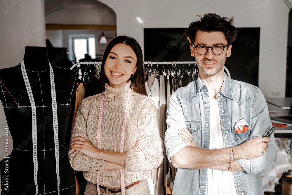 Fototapeta premium Tailoring, dressmaking, designer sphere. Two creative creative people, a man and a woman of different nationalities and races, met to exchange experiences in their favorite business.