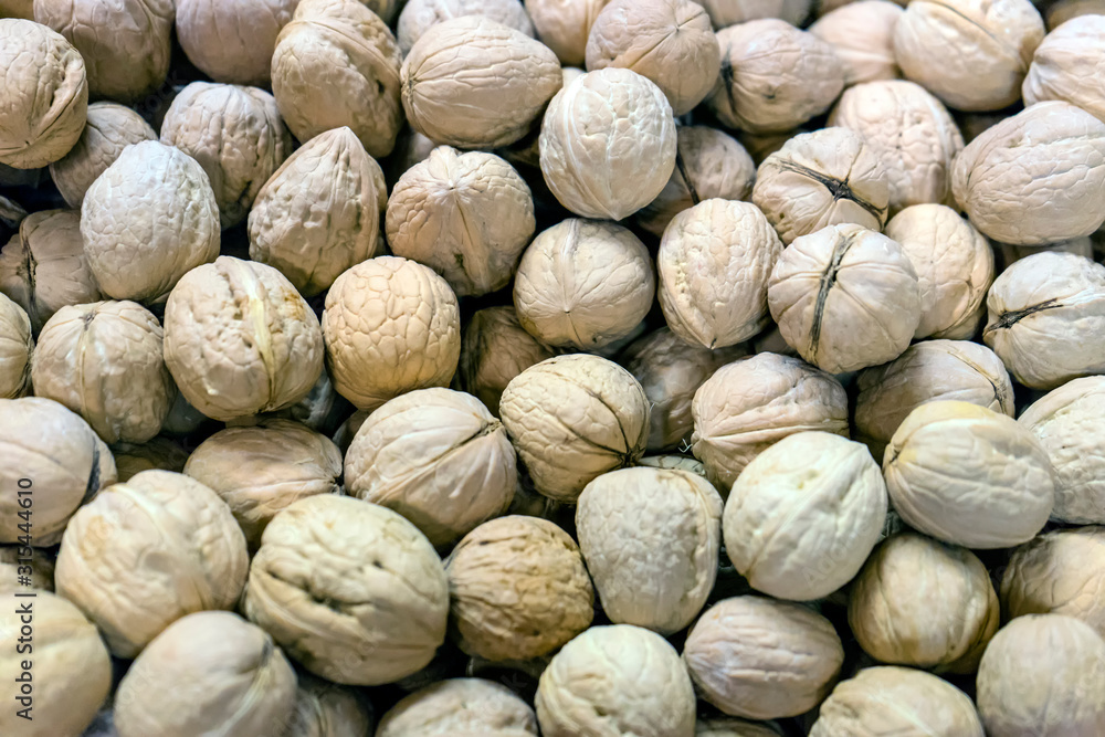 walnuts, unpeeled greek nuts, harvest of walnuts, walnuts closeup, background with walnuts walnuts, unpeeled greek nuts, harvest of walnuts, walnuts closeup, background with walnuts
