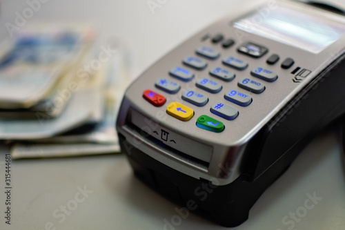 Bank terminal for payment purchases in store by credit cards and paper check receipt. Device for processing payments e-commerce