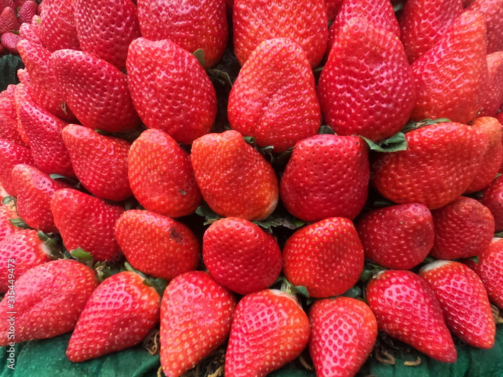 pile of strawberries stacked together pile of strawberries stacked together