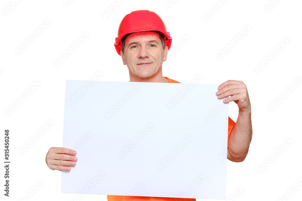 Portrait smiling middle-aged handsome worker wearing red hard hat, looking to the camera and holding blank paper sheet Portrait smiling middle-aged handsome worker wearing red hard hat, looking to the camera and holding blank paper sheet