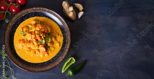 Creamy rich spicy shrimp curry. Seafood dish. View from above, top view. Copy space
