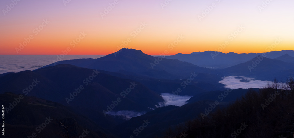 Dawn with mists over the Pyrenees mountains in Euskadi and Navarra, from the Aiako Harriak Natural Park