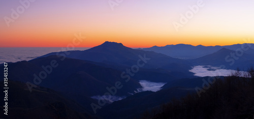 Dawn with mists over the Pyrenees mountains in Euskadi and Navarra, from the Aiako Harriak Natural Park © poliki