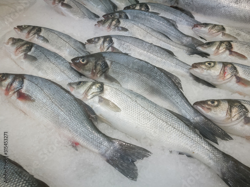 Raw Fresh Fish Chilling on Bed of Cold Ice in Seafood Market Stall. Fish on ice in supermarket.