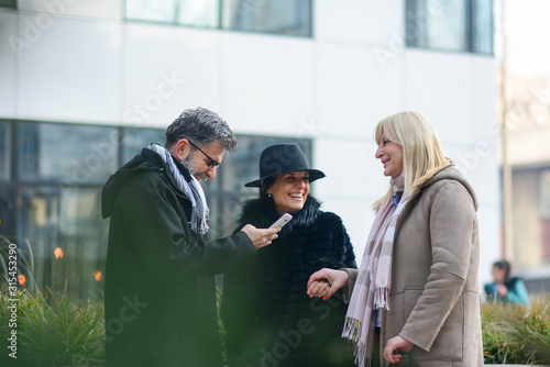 leisure, people and friendship concept. Group Of Friends Having Fun Together Outdoors. Three colleagues on break laughing. Friendship is priceless.