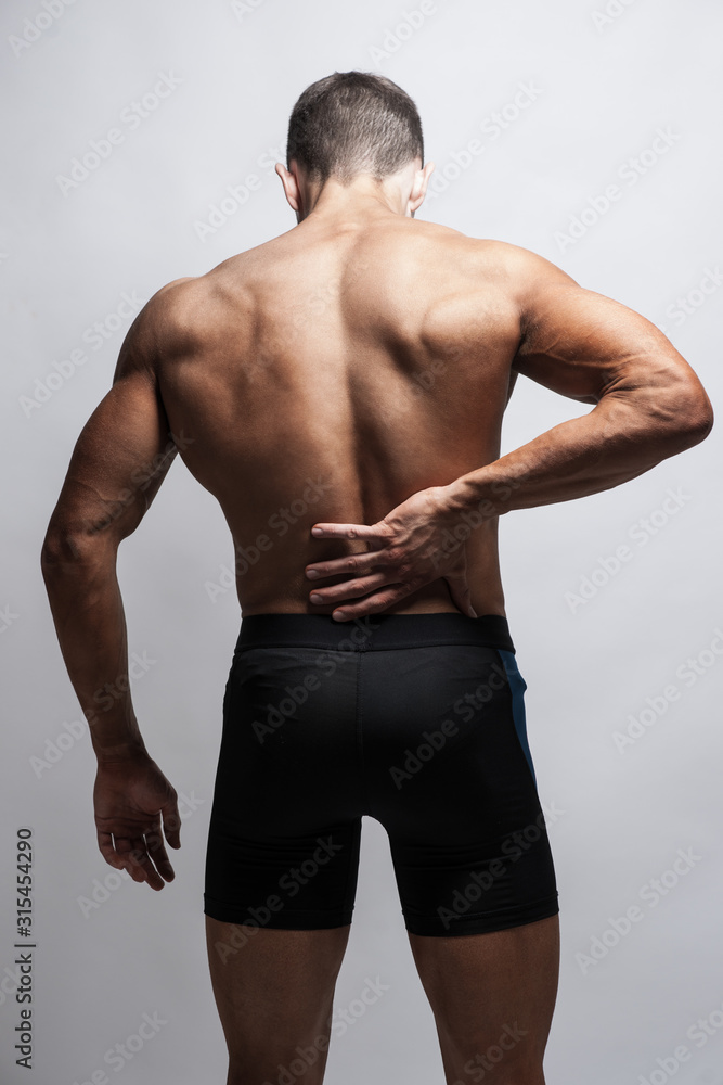 Close up of man rubbing his painful back. Pain relief, chiropractic concept