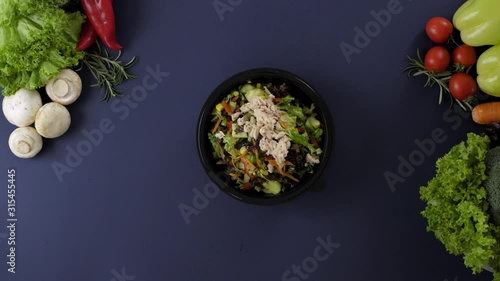 Packing takeaway food in black plastic box. Fresh delivery pack meal with tuna salad