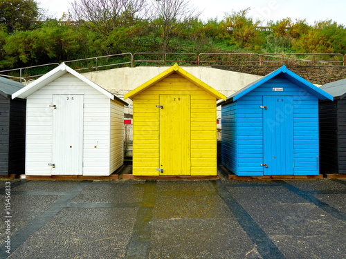 Three beech huts beach huts in primary colours on Lowestoft sea front. © Jonathan Fussell