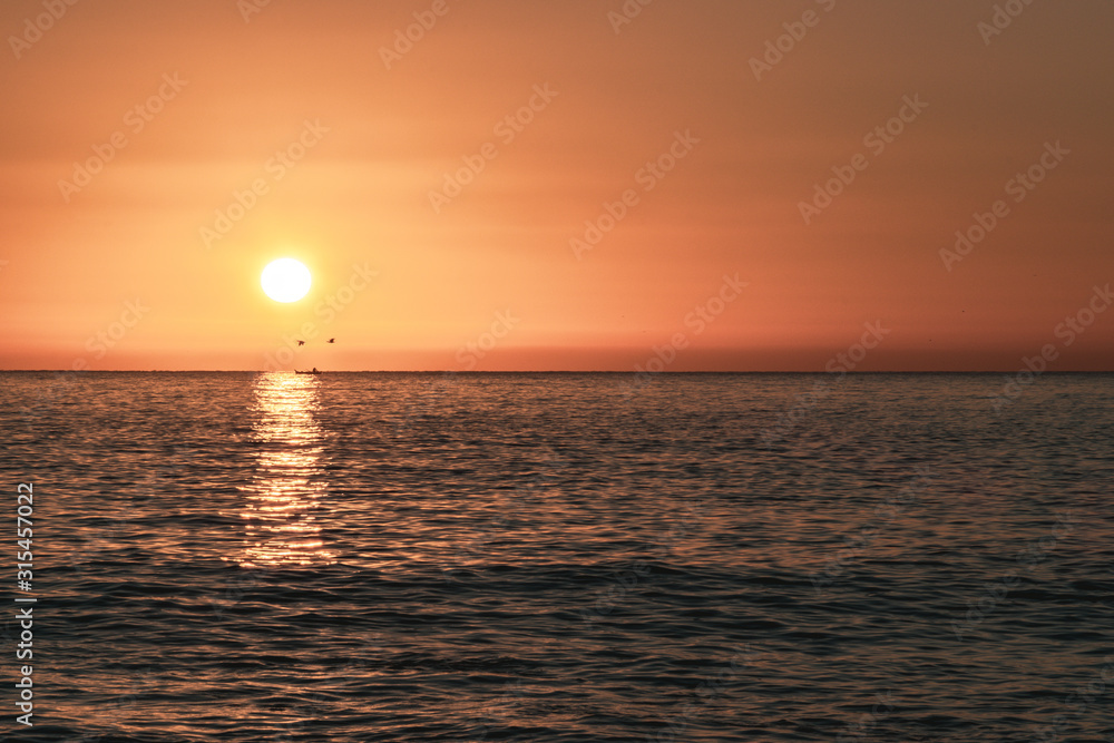 Sunrise over the sea with birds in Acitrezza, Sicily - Italy