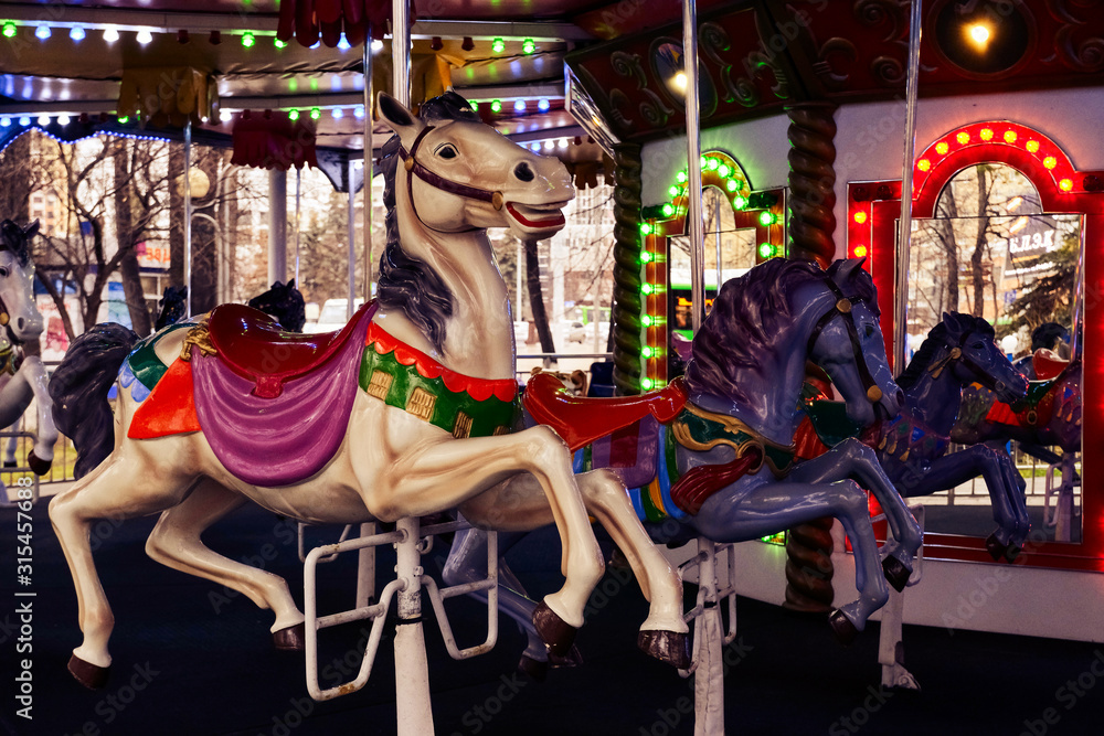 merry-go-round, close-up plastic vintage horse in amusement park