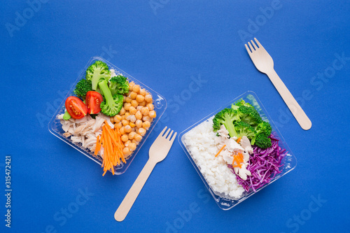 Lunch boxes with healthy food on a bright paper background. Healthy eating concept for the office