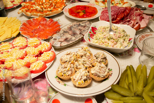 A generous and hospitable table with russian traditional dishes served to the New Year holidays, Christmas, Easter and treats for friends birthday.