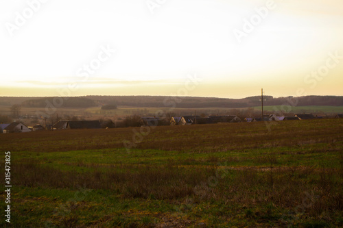 Panoramic view of houses on sunset landscape, old village in Belarus.
