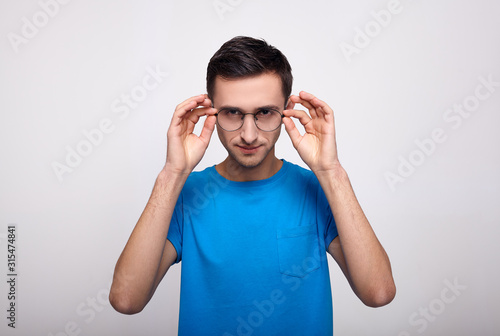 Mysterious young handsome looks directly into the camera.